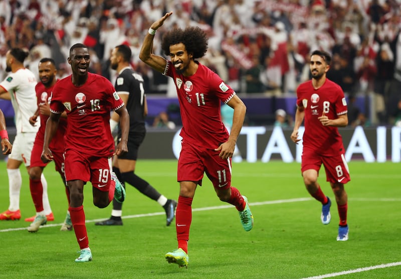 Qatar's Akram Afif celebrates scoring their second goal with teammates. Reuters