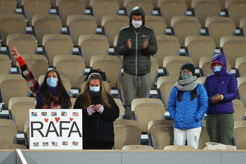 Spectators show their support for Rafael Nadal in the falling temperatures. Getty