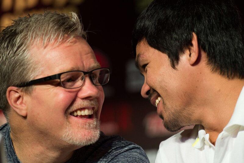 Philippine boxing icon Manny Pacquiao (R) and his coach Freddie Roach talk during a pre-fight press conference in Shanghai on August 26, 2014. Hall of Fame trainer Freddie Roach, who turned 55 on March 5, 2015, has seen it all during a legendary career. But he tells AFP that training Manny Pacquiao to take on Floyd Mayweather on May 2 in boxing's most lucrative fight ever will be "the biggest challenge of my life". AFP PHOTO / JOHANNES EISELE