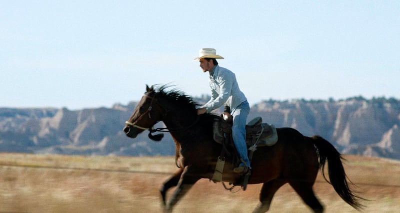 This image released by Sony Pictures Classics shows Brady Jandreau in a scene from "The Rider."  On Saturday, Jan. 5, 2019, The National Society of Film Critics has chosen Chloe Zhao's low-budget debut feature "The Rider" as best picture of 2018. (Sony Pictures Classics via AP)