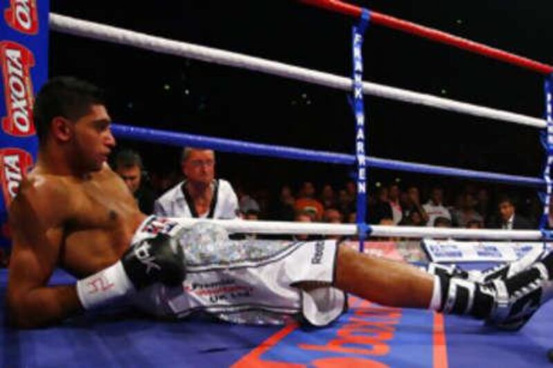 Amir Khan after being knocked out in the first round by Colombian opponent Breidis Prescott at the MEN Arena, Manchester, England.