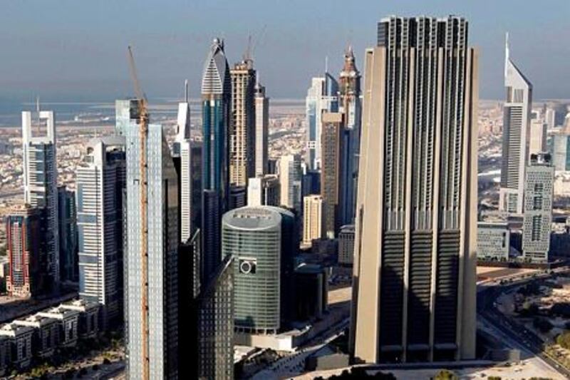 Dubai, United Arab Emirates- December 05, 2010 ;   Aerial view of  Dubai. ( Satish Kumar / The National ) The Index Tower is the tan building, right foreground. One of the Emirates Towers can be seen to the right behind the Index Tower (triangular pointed top with aerial)  The Rose Rayheen hotel by Rotana, center, is the thin pointed building with the ball on top (teal colored). Chelsea Tower Hotel Apartments (by Ramada), left, has a squared white top (semi-closed squared u-shaped).