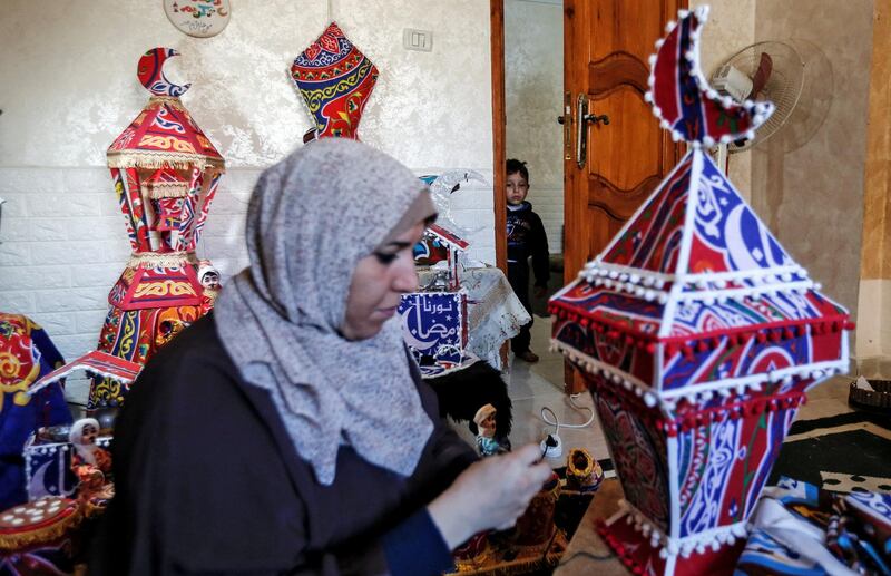 Hanan al-Madhoun, 37, builds a traditional lantern, called a "fanous" used as a decoration to celebrate the start of the Muslim holy month of Ramadan, at her home in Gaza City on April 1, 2021, ahead of the Muslim holy month and amid the coronavirus pandemic. (Photo by MAHMUD HAMS / AFP)