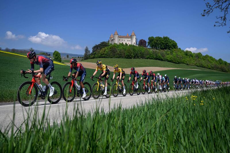 Cyclists ride past Champvent Castle, western Switzerland, during the first stage of the Tour de Romandie 2022 road race. AFP
