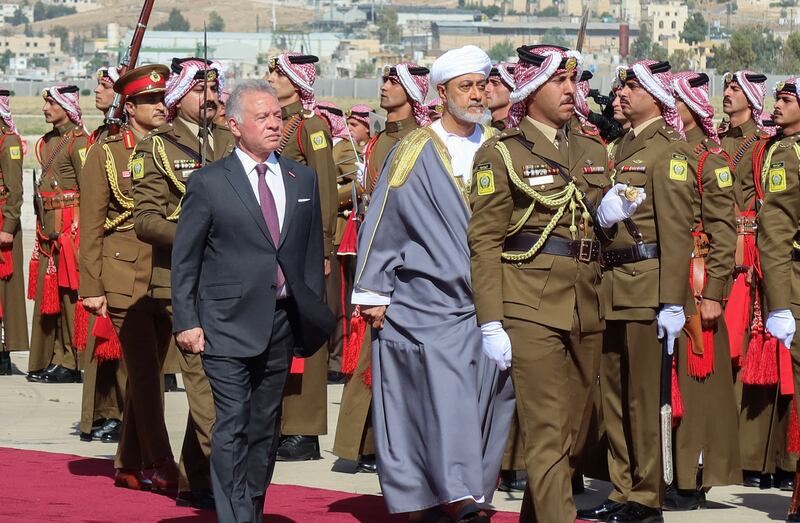 Jordan's King Abdullah reviews an honour guard with Sultan Haitham of Oman on his arrival at Marka Airport in Amman. Reuters