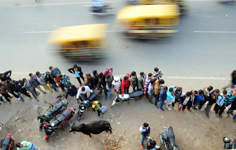 People queue to withdraw money at an ATM in Allahabad, India. Financial services have been transformed by the digital revolution, leading to financial inclusion and more people having a bank account. Photo: Getty