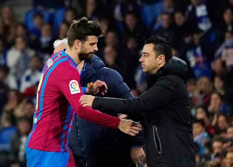 Barcelona coach Xavi hugs Gerard Pique as he is being substituted. Reuters