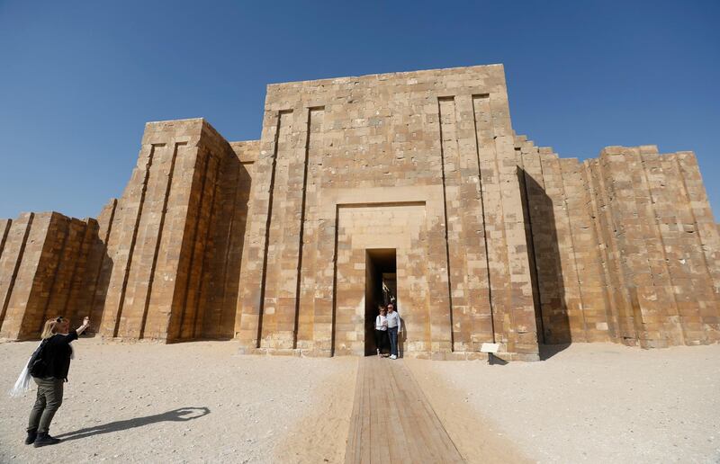 Tourists take pictures at the archaeological site of the Step Pyramind, located in the Saqqara necropolis, south of Cairo, Egypt. Reuters