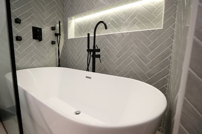 Stephanie Farah installed a standalone bath in the guest bathroom with herringbone tile design. Chris Whiteoak / The National