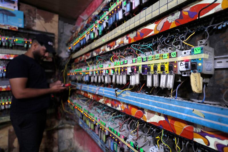 An Iraqi man works at a generator subscription distribution room in Sadr City, east of the capital Baghdad, amid power outages and soaring temperatures.