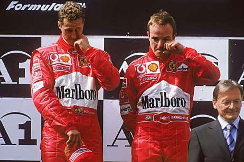Team orders were banned in Formula One after Rubens Barrichello, right, was ordered to let his Ferrari teammate Michael Schumacher past him to take the win at the Austrian Grand Prix in 2002.