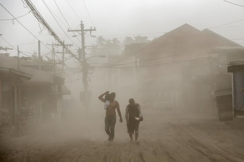 Residents living near the errupting Taal Volcano evacuate in Agoncillo, Batangas City. Reuters