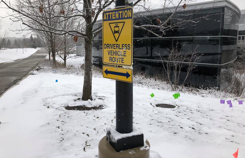 A sign marks part of a route used to test a driverless electric shuttle at the University of Michigan in Ann Arbor, Michigan, U.S. March 7, 2018. Picture taken March 7, 2018. REUTERS/Paul Lienert