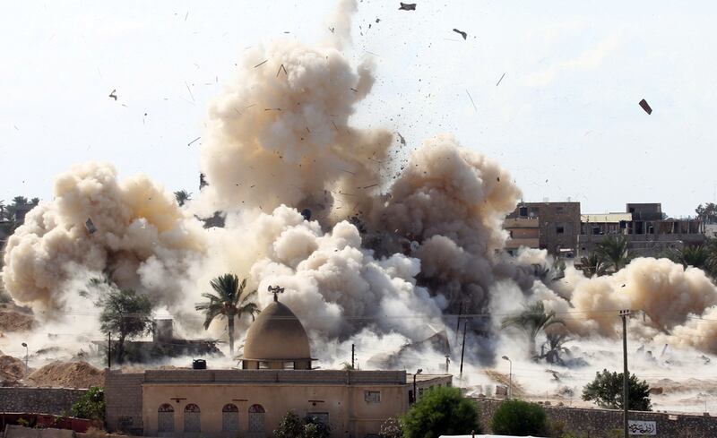 Smoke rises after a house was blown up during a military operation by Egyptian security forces in the Egyptian city of Rafah. Said Katib / AFP