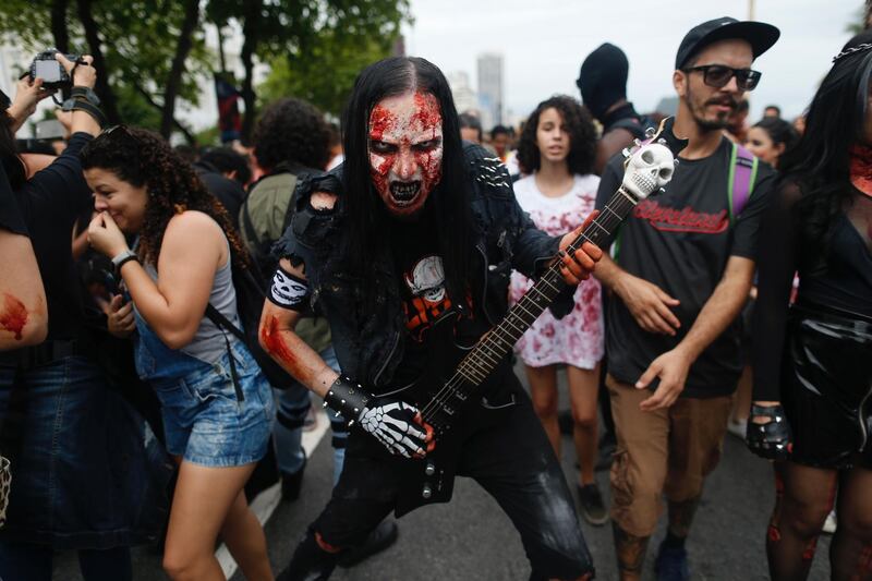 People in costumes participate during the "Zombie Walk." AFP