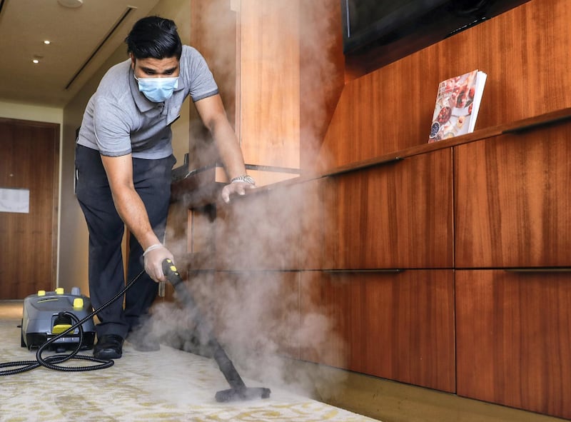 Abu Dhabi, United Arab Emirates, August 12, 2020.   Media Tour at The Westin Abu Dhabi Golf Resort & Spa on how tourism officials are conducting the go safe certification for hotels against Covid-19.  A hotel cleaner steams the carpet of a room.Victor Besa /The NationalSection:  NAReporter:  Haneen Dajani