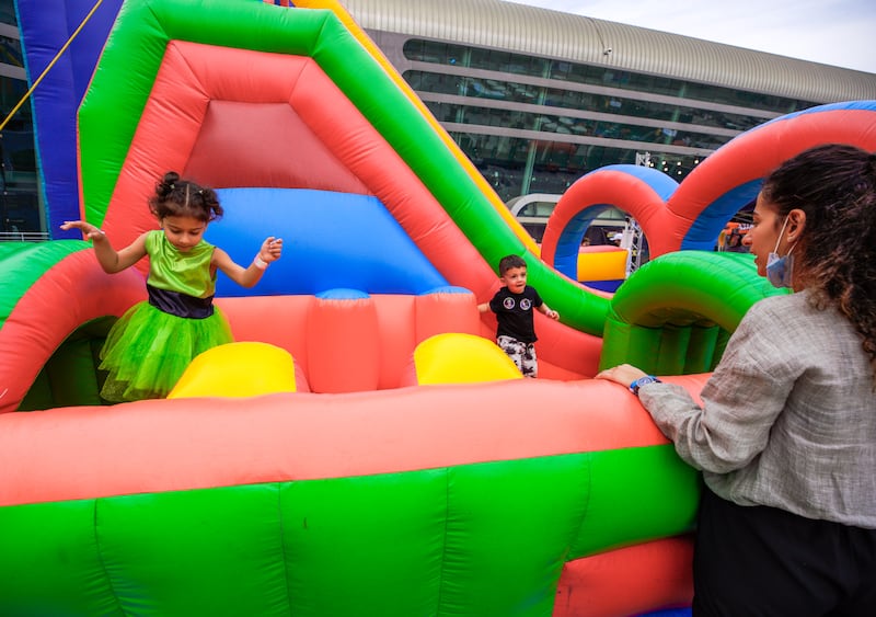 Children enjoy an inflatable playhouse in the Party Plaza area.