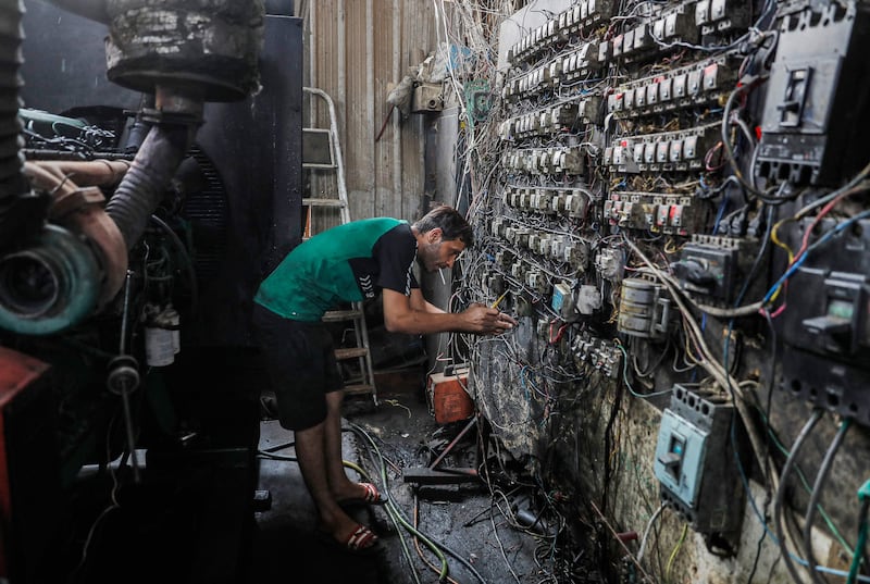 A technician at an electric switchboard that connects homes to privately owned electricity generators in a suburb of Baghdad, where the national electricity grid is experiencing failures during the severe heat wave.