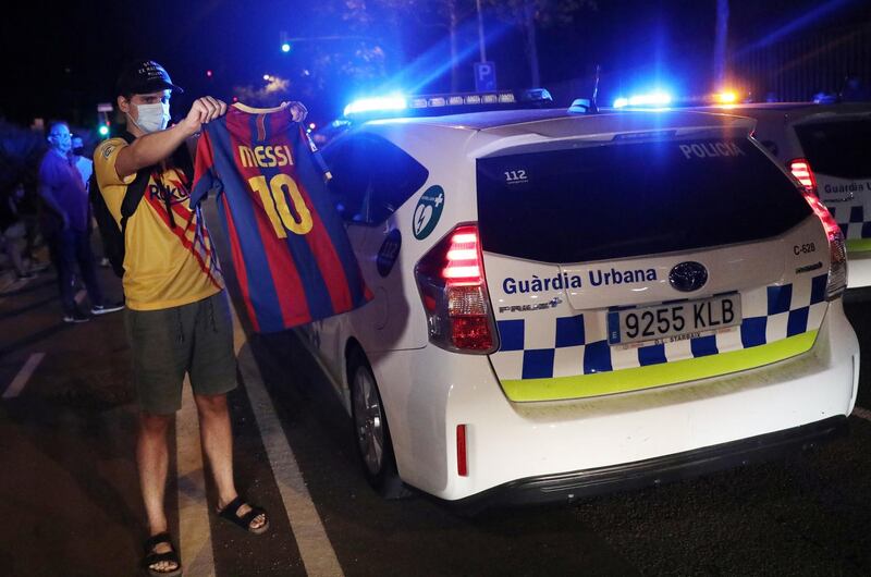 A Barcelona fan holds up a Lionel Messi shirt outside the Camp Nou. Reuters