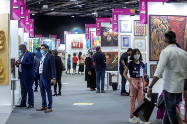 Visitors walk through an art trade fair at the Dubai World Trade Centre. Over the coming months, Dubai will host major events, including Arabian Travel Market and Arab Health, among others, as it safely re-opens for large-scale global events. Photo: Leslie Pableo for The National