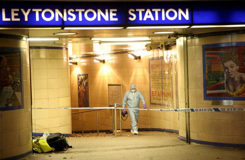 Police officers investigate a crime scene at Leytonstone underground station in east London. Neil Hall / Reuters