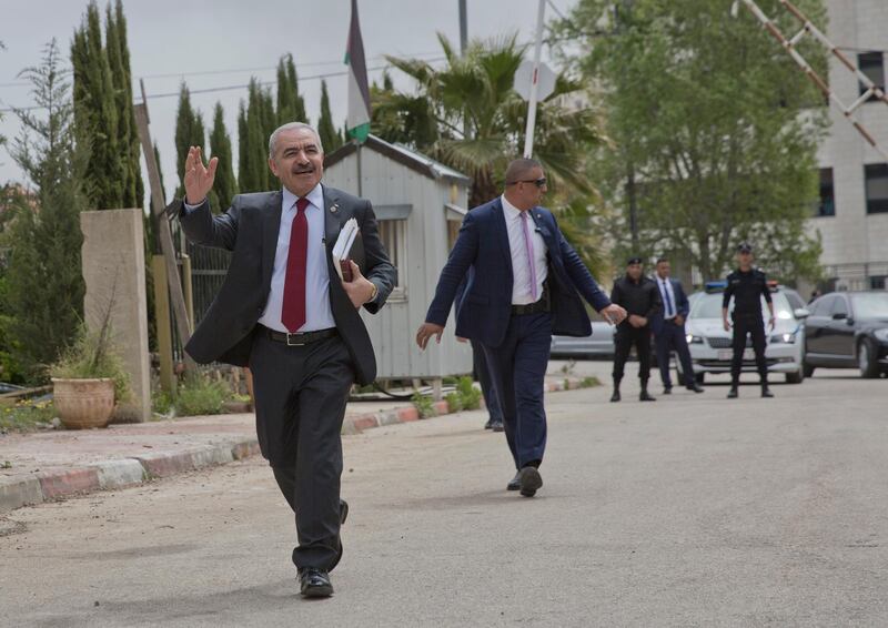 Palestinian Prime Minister Mohammed Ishtayeh arrives for his first cabinet meeting, at his office in the West Bank city of Ramallah, Monday, April. AP