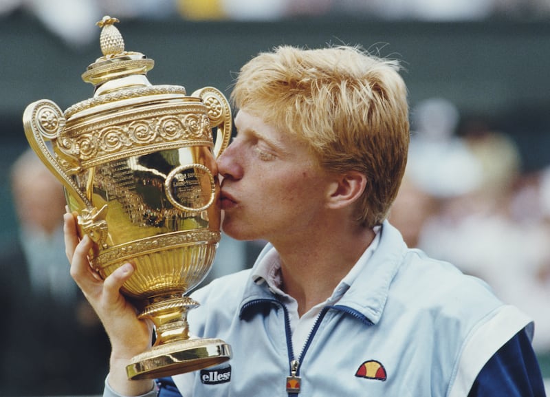 Boris Becker kisses the Wimbledon Men's Singles trophy, after his 1985 victory over South Africa's Kevin Curren at the London tournament. Getty Images