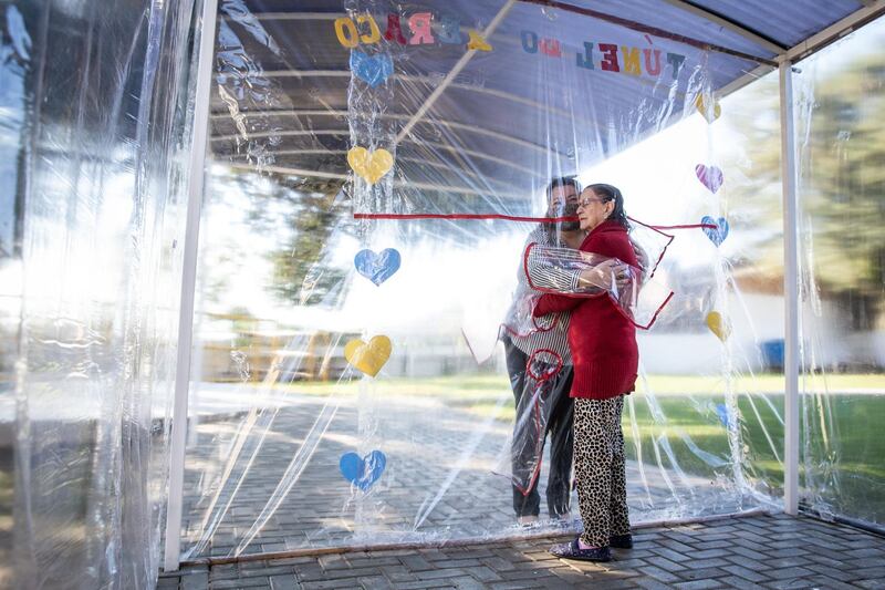 A daughter hugs her mother at the Geriatric Clinic Três Figueiras  in Gravatai, Brazil. Getty