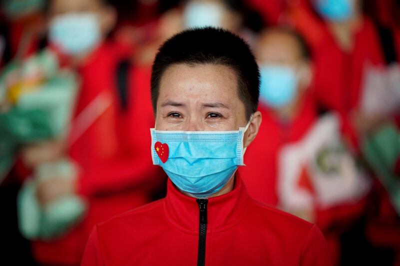 A member of a medical team weeps at the Wuhan Tianhe International Airport after travel restrictions were lifted. Reuters