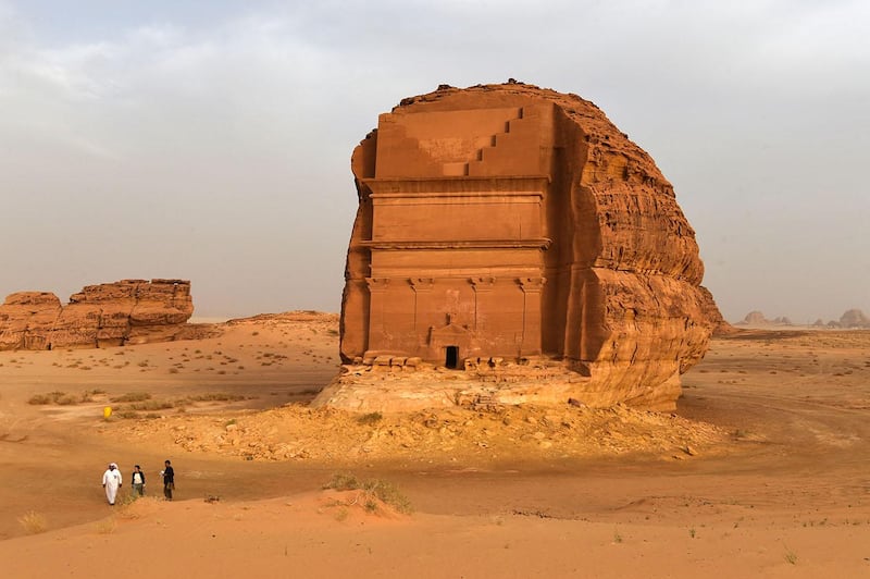 A picture taken on March 31, 2018 shows a Saudi man standing at the entrance of a tomb at Madain Saleh, a UNESCO World Heritage site, near Saudi Arabia's northwestern town of al-Ula. - Al-Ula, an area rich in archaeological remnants, is seen as a jewel in the crown of future Saudi attractions as the austere kingdom prepares to issue tourist visas for the first time -- opening up one of the last frontiers of global tourism. Saudi Crown Prince Mohammed bin Salman is set to sign a landmark agreement with Paris on April 10, 2018 for the touristic and cultural development of the northwestern site, once a crossroads of ancient civilisations. (Photo by FAYEZ NURELDINE / AFP)