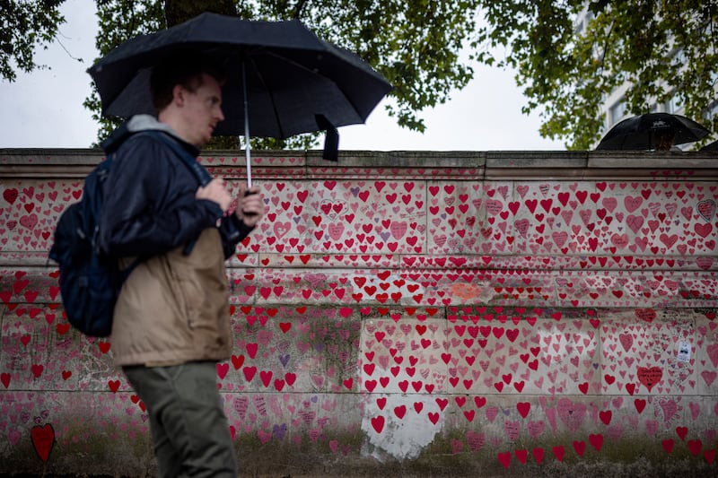 A man walks along the National Covid Memorial Wall in London. A report has said mistakes, delays and failures in the UK's Covid-19 response cost lives. Getty Images