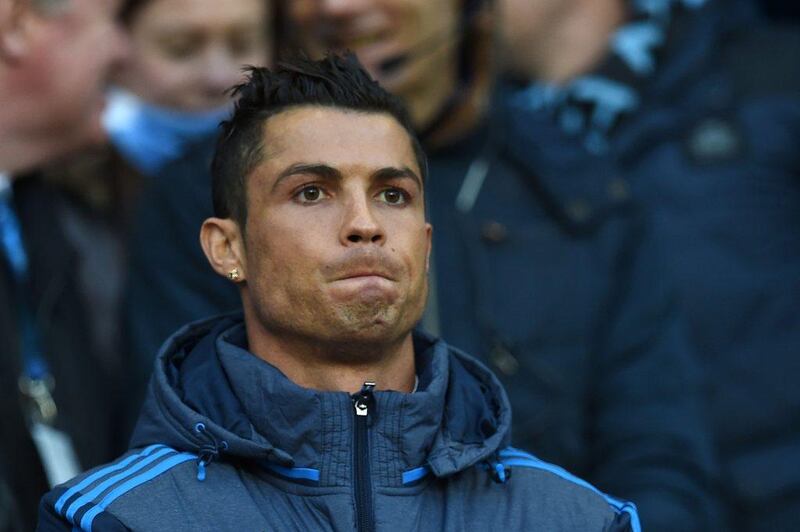 Real Madrid forward Cristiano Ronaldo watches from the crowd as a spectator. Paul Ellis / AFP