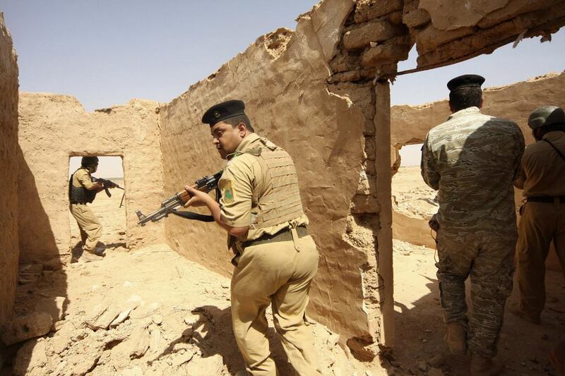 Members of Iraqi security forces take their positions during a patrol looking for militants of the Islamic State of Iraq and the Levant (ISIL) west of Kerbala, June 29, 2014. Mushtaq Muhammed/Reuters