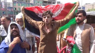 People carry Afghan flags as they take part in an anti-Taliban protest in Jalalabad, Afghanistan.