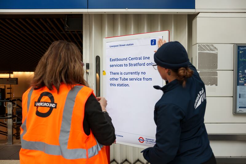 Employees at Liverpool Street railway station place a service notice. Bloomberg