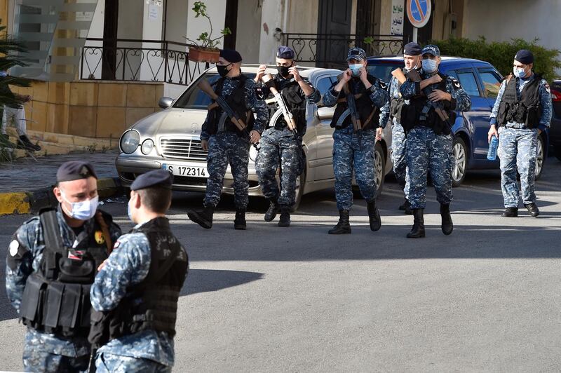 Lebanese policemen stand guard outside a detention center after dozens of prisoners escaped in Baabda.  EPA