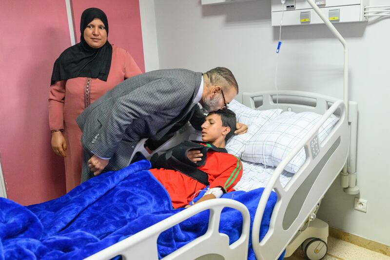 King Mohammed VI of Morocco kisses an injured boy on the forehead while visiting earthquake survivors at a hospital in Marrakesh on Wednesday. Photo: MAP