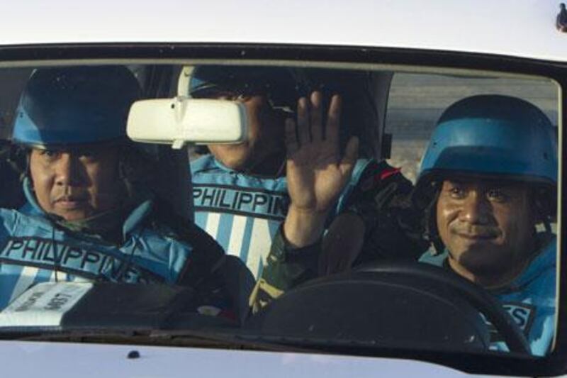 UN peacekeepers of the United Nations Disengagement Observer Force cross a checkpoint between Israel and Syria in the occpupied Golan Heights on Saturday. A group of 21 Filipino UN peacekeepers seized by Syrian rebels on the Golan were freed on Saturday. AFP