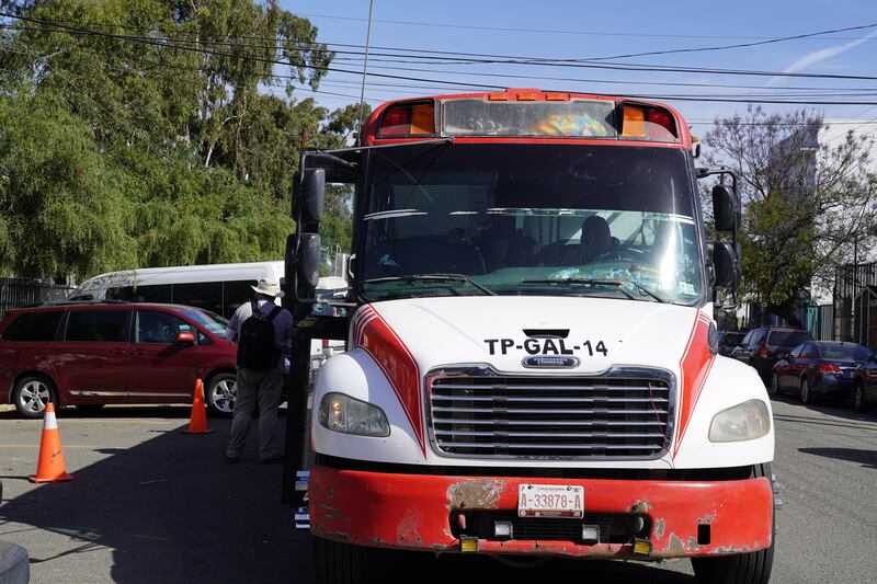 A bus carrying refugees is parked in front of the sports complex where Ukrainians are staying in Tijuana.