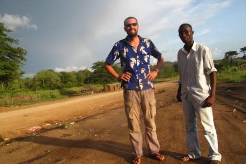 Roger and Danny on the side of the road from Soyo to Luanda. For Scott MacMillan travel column. Photo by Scott MacMillan.