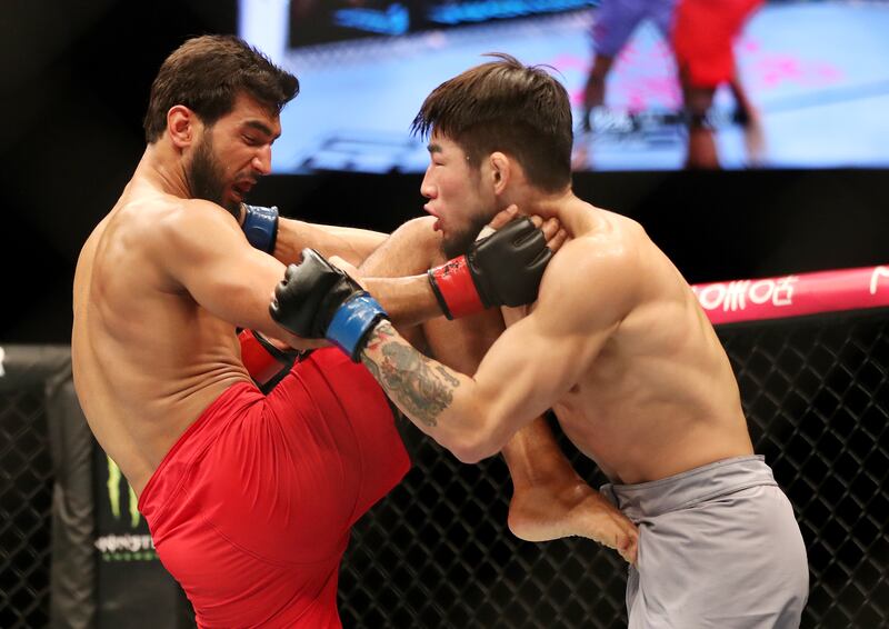 Anshul Jubli, red, takes on Kim Kyeong-Pyo in Abu Dhabi. Chris Whiteoak / The National