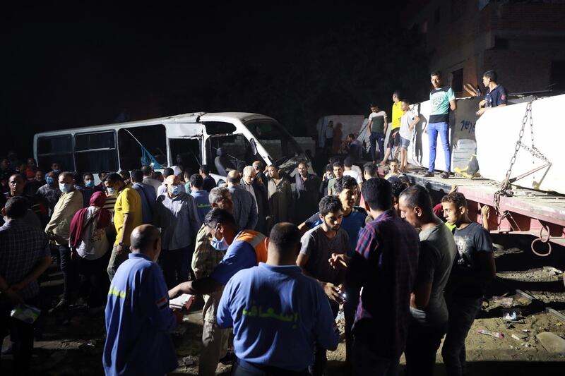 The Egyptian ministry of health said at least two people died and six were injured after a cargo train crashed into two minibuses crossing the railway in an unregulated area. EPA