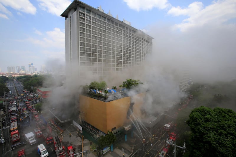 Firefighters douse water after a fire engulfed the Manila Pavilion hotel in Metro Manila, Philippines on March 18, 2018. Romeo Ranoco / Reuters