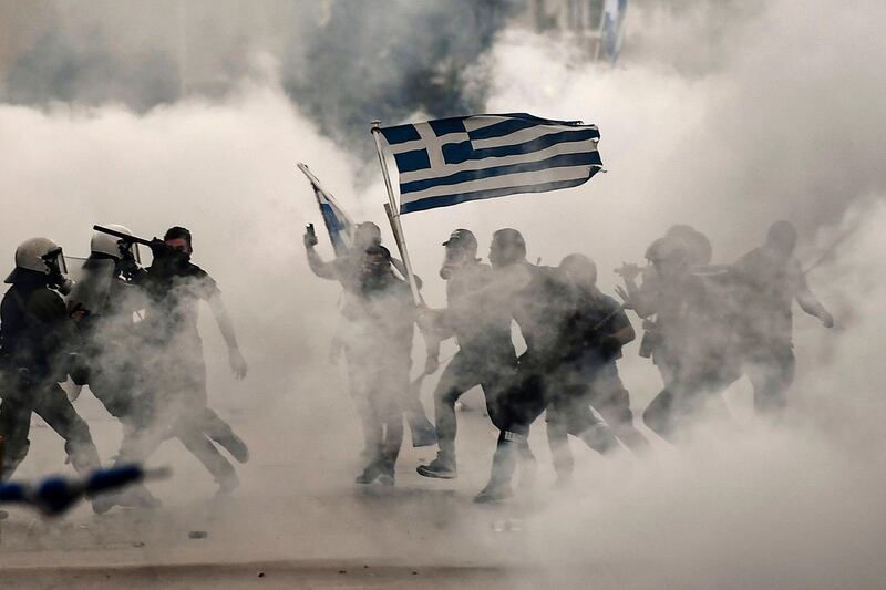 TOPSHOT - Protesters clash with police during a demonstration against the agreement reached by Greece and Macedonia to resolve a dispute over the former Yugoslav republic's name, during the opening of the 83rd Thessaloniki International Fair (TIF), on September 8, 2018 in Thessaloniki. (Photo by Aris MESSINIS / AFP)