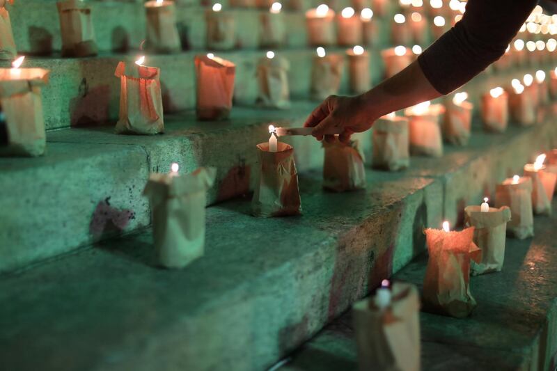A person takes part in an event to light candles in honour of the 500,000 people who have died from Covid-19 in Brazil, in Rio de Janeiro, Brazil. Reuters
