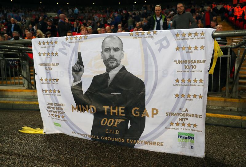 A banner bearing a picture of Pep Guardiola dressed as James Bond. Catherine Ivill / Getty Images