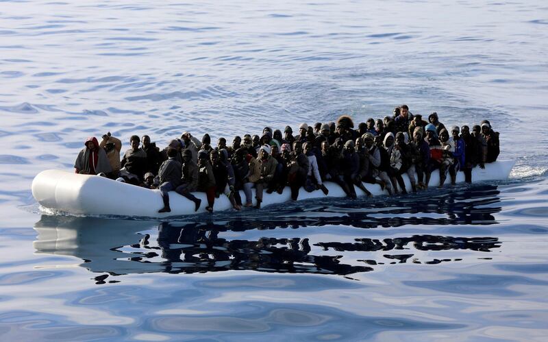 FILE PHOTO: Migrants are seen in a rubber dinghy as they are rescued by Libyan coast guards in the Mediterranean Sea off the coast of Libya, January 15, 2018. Picture taken January 15, 2018. REUTERS/Hani Amara/File Photo