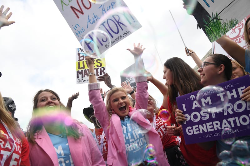 Pro-life campaigners celebrate outside the Supreme Court. AFP