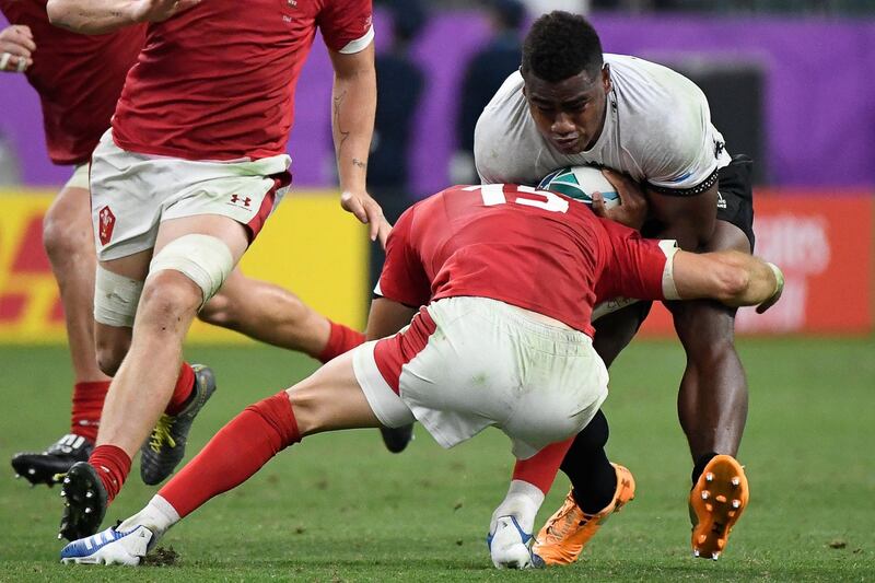 Fiji's wing Josua Tuisova (R) is tackled by Wales' full back Liam Williams during the Japan 2019 Rugby World Cup Pool D match between Wales and Fiji at the Oita Stadium in Oita. AFP