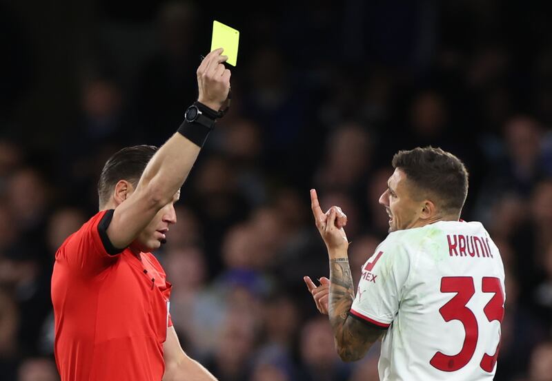 Referee Danny Makkelie shows a yellow card to Milan's Rade Krunic in the first-half. EPA